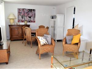 a living room with wicker chairs and a table at Appartement Trégastel, 2 pièces, 4 personnes - FR-1-368-77 in Trégastel