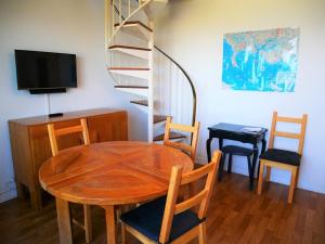 comedor con mesa, sillas y TV en Appartement Quiberon, 2 pièces, 5 personnes - FR-1-478-125, en Quiberon