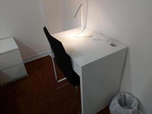 a white desk with a chair and a lamp on it at Guest House Room No 03 in Mississauga