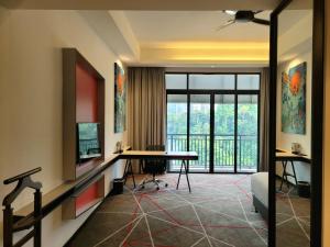 a living room with a desk and a balcony at M101 Kuala Lumpur by Asiapex in Kuala Lumpur