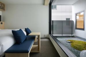 Postel nebo postele na pokoji v ubytování HOTEL KYOTOLOGY
