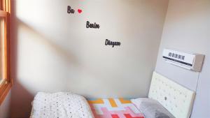 a bedroom with a bed and a wall with words on it at Sweet Home Kadıköy in Istanbul