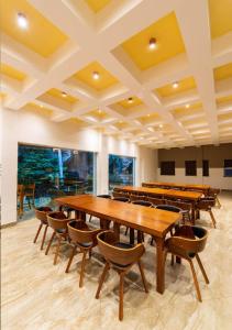a conference room with wooden tables and chairs at Grand Rockland Hotel in Matara