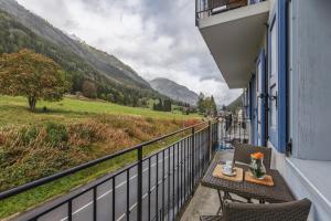a balcony with a table and a view of a valley at Vallorcine Apartments - Happy Rentals in Vallorcine