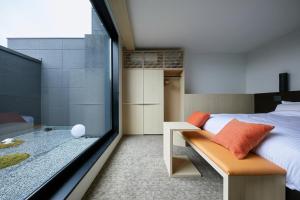 Postel nebo postele na pokoji v ubytování HOTEL KYOTOLOGY