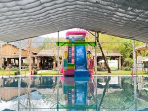 a water park with a water slide in a pool at YCC Forest Campsite in Puli