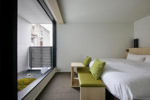 Postel nebo postele na pokoji v ubytování HOTEL KYOTOLOGY