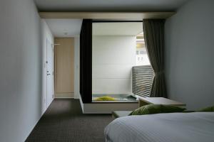 Postel nebo postele na pokoji v ubytování HOTEL KYOTOLOGY