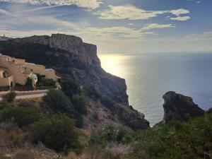 a view of the ocean from a hill with houses at la ventana al mar in Jávea