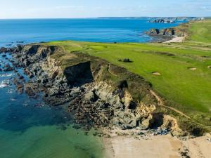 an aerial view of a golf course on the ocean at Ocean View Apartment in Thurlestone