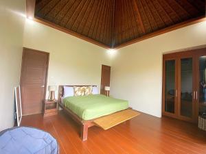 a bedroom with a bed and a wooden floor at Villa Mudha 3 Sanur in Sanur +44 photos