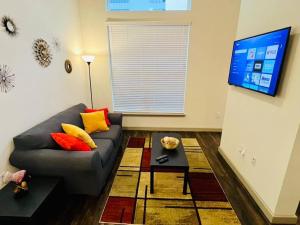 a living room with a couch and a tv at Apto 1 Bed - Kitchen - FREE Parking in Houston