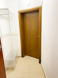 a wooden door in a room with a tile floor at Stylish apartment, very good located! in Sofia