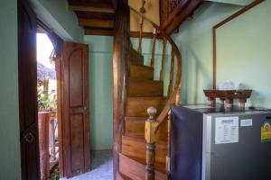 a kitchen with a staircase and a refrigerator in a room at The Aerie in Pang Mapha
