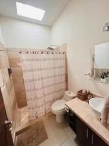 a bathroom with a shower and a toilet and a sink at CASA LUNA , para 6 personas in La Paz