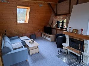 a living room with a blue couch and a fireplace at Haus Erna Schierke in Schierke