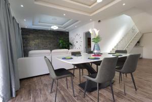 a dining room with a white table and chairs at villa de la lumiere in Trou aux Biches