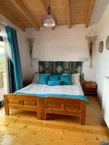 a bedroom with a large bed with blue pillows at The lodge in Mesongi