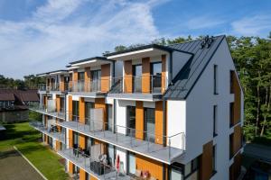 an aerial view of a building with balconies at Luxurious Little Laguna Apartments SPA & Gym by Renters Prestige in Międzywodzie