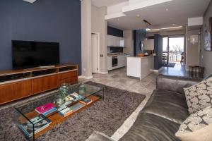 a living room with a couch and a coffee table at Luxury 2 bed apart 515 Harbour Bridge, Dockrail Road, Foreshore, Cape Town, 8001, in Cape Town