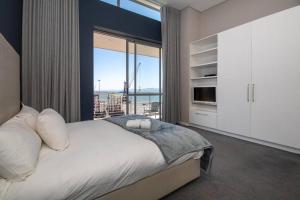 a bedroom with a large bed with a large window at Luxury 2 bed apart 515 Harbour Bridge, Dockrail Road, Foreshore, Cape Town, 8001, in Cape Town