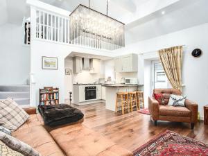 a living room with a couch and a kitchen at The Old Barn - Uk40948 in Auchtermuchty