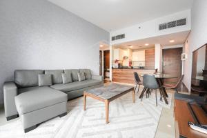 a living room with a couch and a table at KeyHost - Elegant 1BR at Sparkle Tower Dubai Marina - K2630 in Dubai