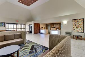 a living room with two couches and a table at Holiday Inn Express & Suites Bad Axe, an IHG Hotel in Bad Axe