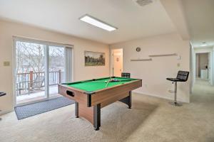 a room with a pool table and a chair at Gas Grill, Lake Access Scenic Poconos Retreat! in East Stroudsburg