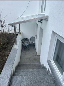 um pátio com uma mesa e uma cadeira ao lado de um edifício em Apartment em Reutlingen