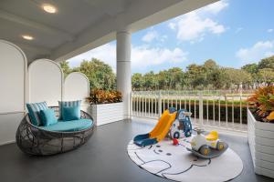 a screened in porch with two chairs and a toy car at Yuehua Hotel Xiamen Seaside Hotel in Xiamen