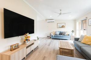a living room with a large flat screen tv on a wall at Blairgowrie Whitesands - stay 3 nights for FREE WINE in Blairgowrie