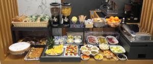 a table with a bunch of different types of food at Concept Terrace Hotel in Rome