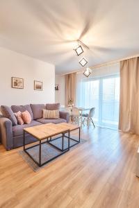 a living room with a couch and a table at LAGUNA Apartament Polanica Residence 21 in Polanica-Zdrój