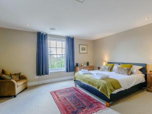 a bedroom with a large bed and a window at Anchor Light Cottage in Faversham