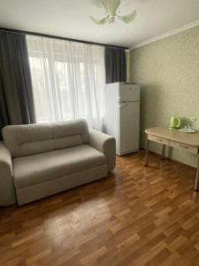 a living room with a couch and a table at Zarea Hotel in Chişinău