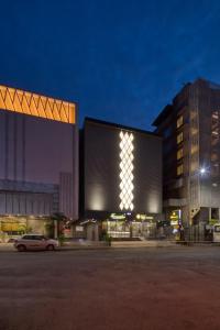 a building with a car parked in front of it at Hotel Sifat International in Surat