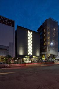 a large building with lights on it at night at Hotel Sifat International in Surat