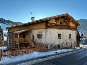 a large building with a fence in front of it at Alpin Chalet Samer Apt Bauernstube in Sarntal