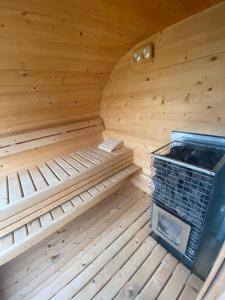 a wooden sauna with a cage in the middle at Amaretto Apartamenty-Solina in Solina