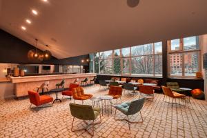 a lobby with a bar with chairs and tables at COWOOL GRENOBLE in Grenoble