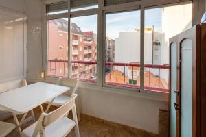 a table and chairs in a room with a window at Mtsrat8 in Torrevieja