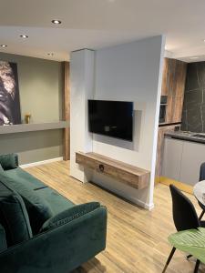a living room with a couch and a flat screen tv at Siauliai ‘Four sisters’ in Šiauliai