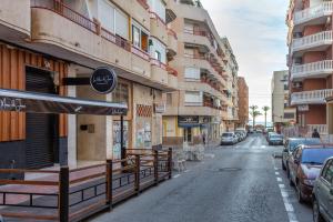 a street with cars parked on the side of a building at Mtsrat8 in Torrevieja