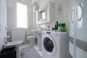 a white bathroom with a washing machine in it at B & B L'ABBRACCIO in Agnone
