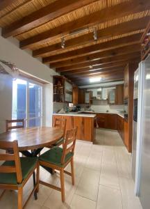a large kitchen with a wooden table and chairs at The Family Nest - Traditional Serenity in Nicosia