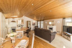 a large living room with a couch and a table at Birch 23 Hot Tub in Garton