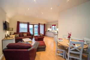 a living room with a couch and a table at Hawthorn 19 Hot Tub in Garton