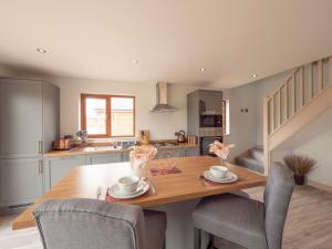 a kitchen and dining room with a wooden table and chairs at Cherry 32 Hot Tub-2 Storey in Hull