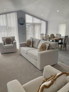 a living room with a white couch and a table at Cherry Blossom 37 Hot Tub in Garton